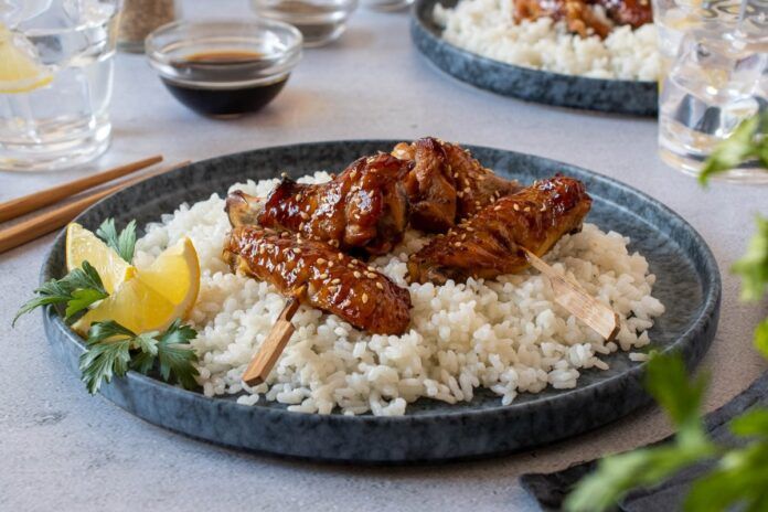 plato de alitas de pollo en salsa teriyaki con guarnicion de arroz