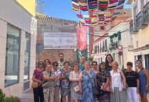 Instalación de los coloridos toldos de croché elaborados por mujeres voluntarias en las calles del centro de Herencia durante el verano.